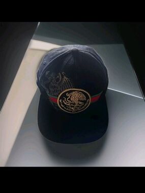 Black Baseball Cap with Gold Emblem and Red-Green Stripe